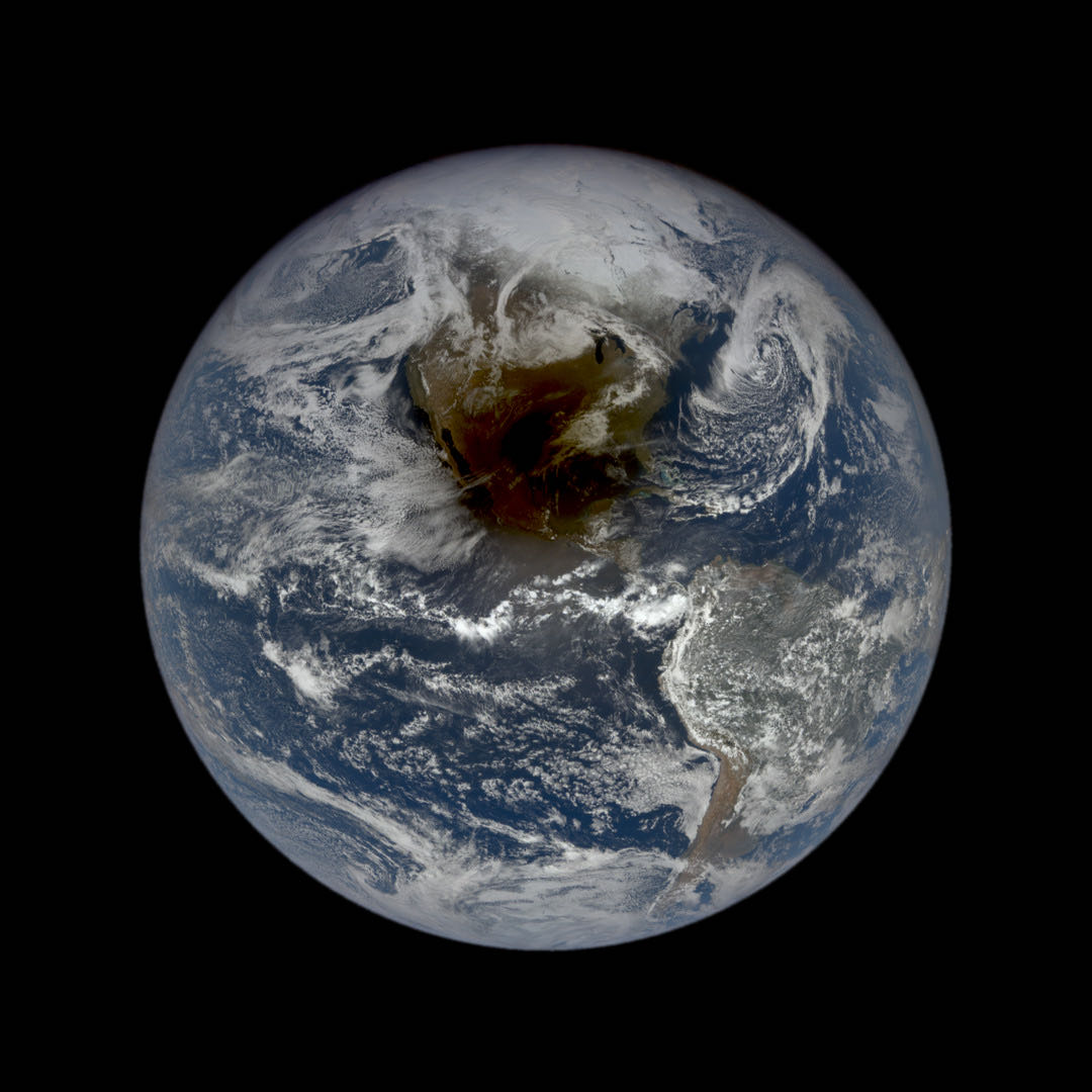 Earth from a million miles out on Apr 8, 2024, with the Moon's dark shadow on it